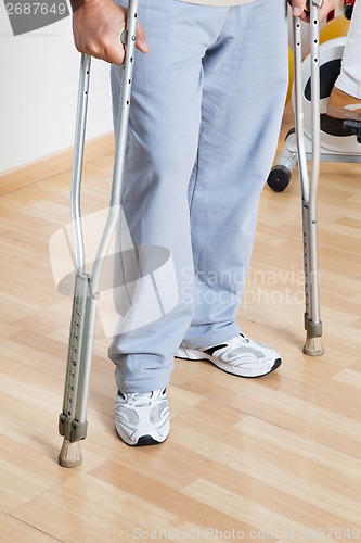 Image of Woman Standing With Crutches