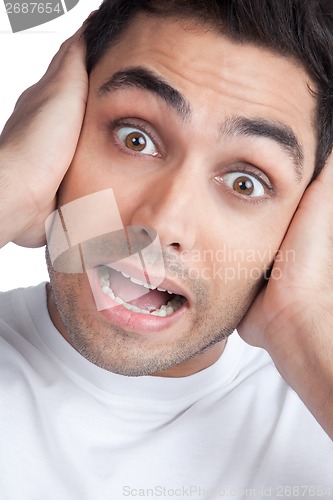 Image of Young Asian Man Covering Ears