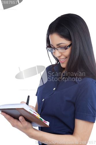 Image of Businesswoman Writing on Notebook