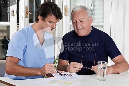 Image of Mature Man playing Sudoku Puzzle