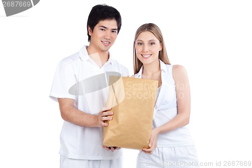 Image of Young Couple  Holding Paper Bag