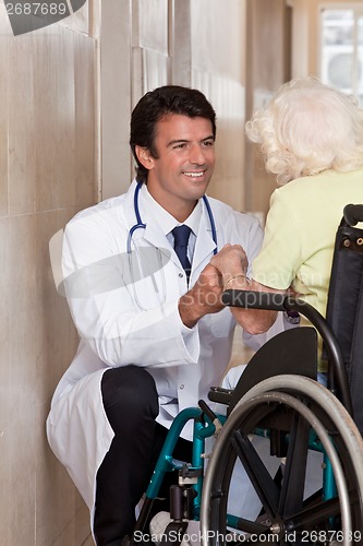 Image of Doctor with Patient on Wheel Chair