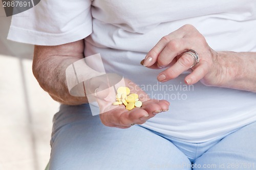 Image of Sick Woman taking her Pills