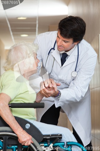 Image of Doctor Comforting Senior Patient At Hospital