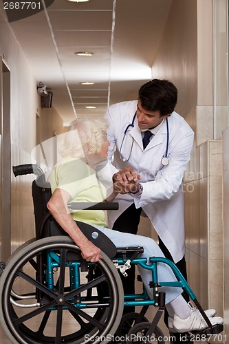 Image of Doctor with Patient on Wheel Chair