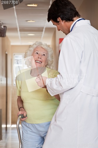 Image of Doctor helping Patient use Walking Stick