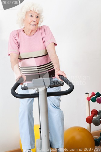 Image of Happy Senior Woman Exercising On Bike