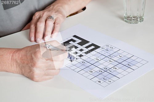 Image of Mature Woman playing Sudoku Puzzle