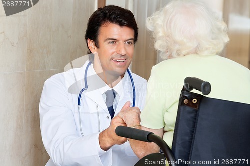 Image of Doctor With Senior Woman In Wheel Chair