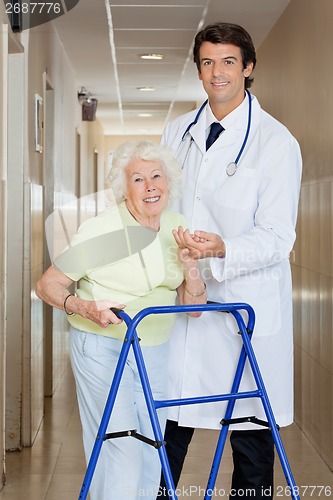 Image of Doctor Helping An Old Woman With Her Walker