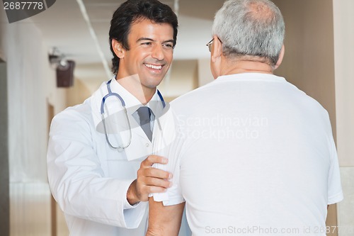 Image of Doctor Assisting Senior Man