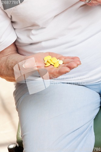 Image of Senior Female Patient Holding Tablets