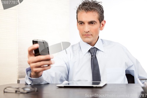 Image of Businessman Using Cell Phone