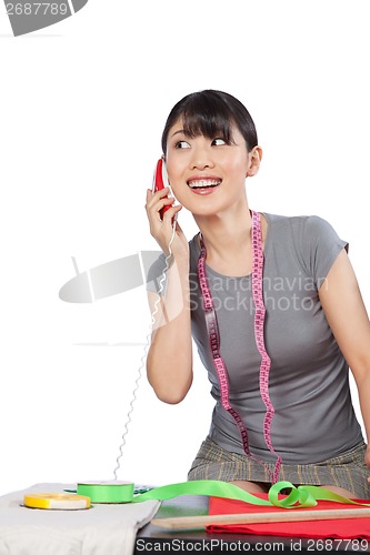 Image of Woman Dressmaker on Phone