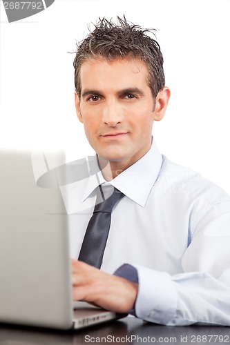 Image of Businessman Using Laptop At Work