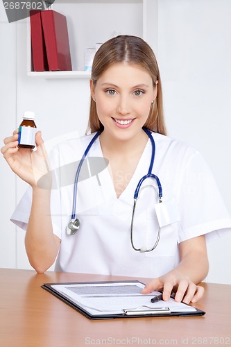 Image of Doctor Holding Medicine Bottle