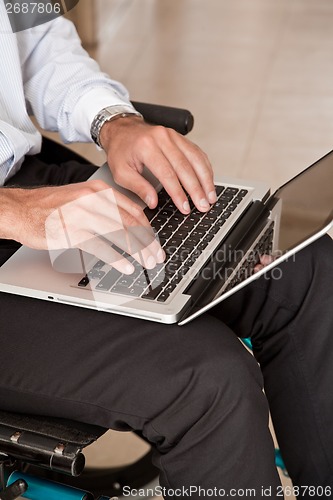 Image of Man on Wheelchair Using Laptop