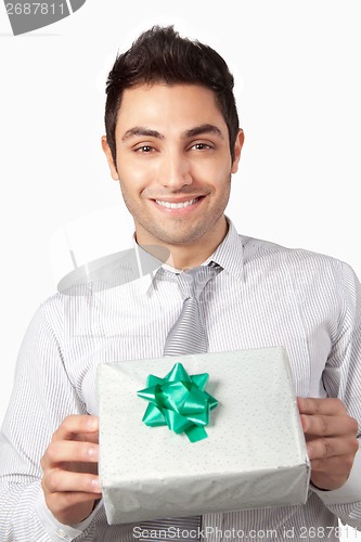Image of Young Businessman Holding Gift Box