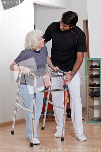 Image of Therapist helping Patient use Walker