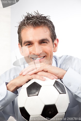 Image of Businessman with Football at Work