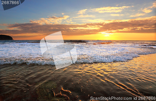 Image of Waves crash onto the rock shelf at high tide