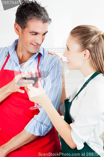 Image of Happy Couple Cooking in Kitchen