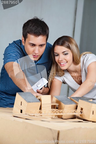 Image of Couple Working On Model House