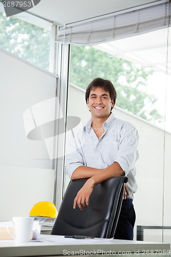 Image of Architect Standing By Office Chair
