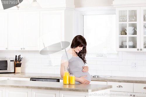 Image of Pregnant Woman Looking at Belly