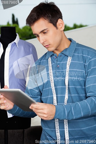 Image of Male Tailor Holding Tablet PC