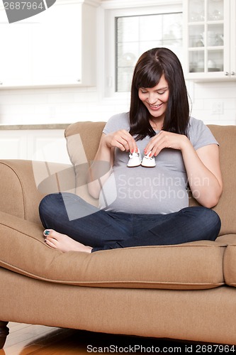 Image of Happy Pregnant Woman with Baby Shoes