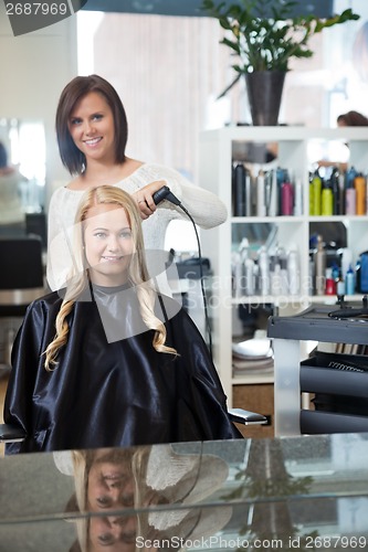 Image of Woman Getting Her Hair Curled