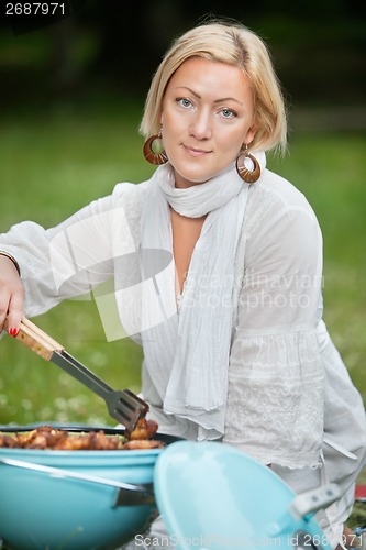 Image of Female Preparing Food On Barbecue