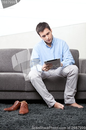 Image of Young Man Using Digital Tablet