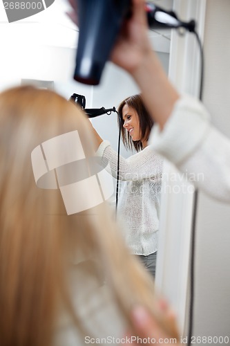 Image of Beautician Blow Drying Hair Of Female Customer