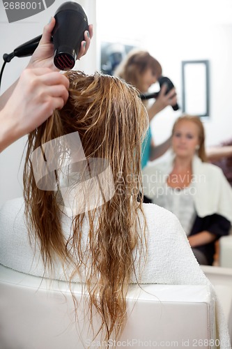 Image of Drying Hair With Blow Dryer