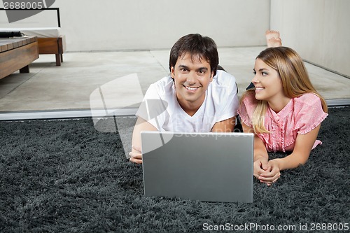 Image of Couple With Laptop On Rug