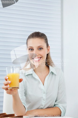 Image of Happy Businesswoman Holding Orange Juice