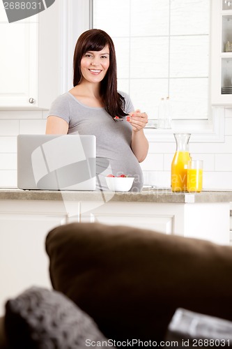 Image of Happy Pregnant Woman Eating