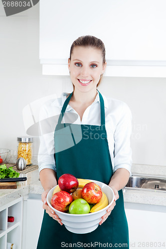 Image of Woman with Fruit in Kitchen