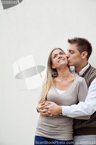 Image of Young Man Kissing Girlfriend