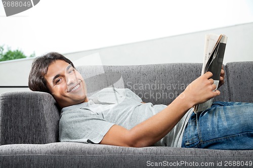 Image of Man Holding Magazine