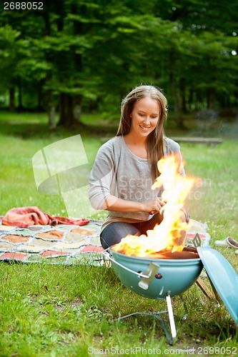 Image of Female Preparing Meal On Flaming Barbecue