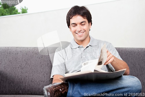 Image of Young Man Reading Newspaper