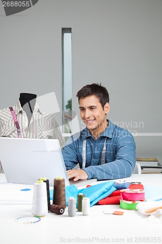 Image of Happy Tailor Working On Laptop