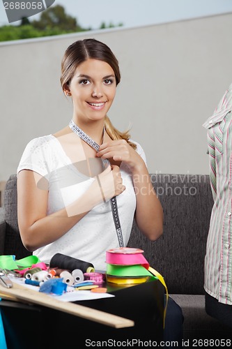 Image of Woman Taking Measurement Of Neck