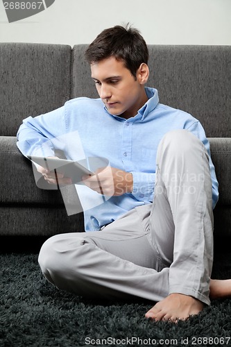 Image of Relaxed Man Using Digital Tablet