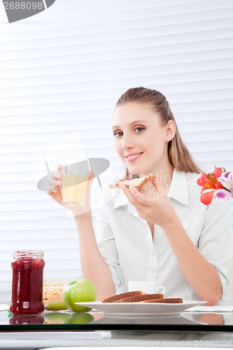 Image of Young Woman Having Breakfast