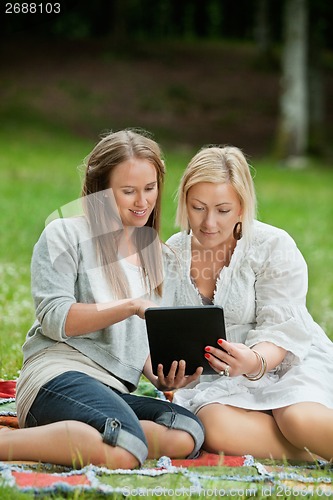 Image of Mother And Daughter Using Digital Tablet