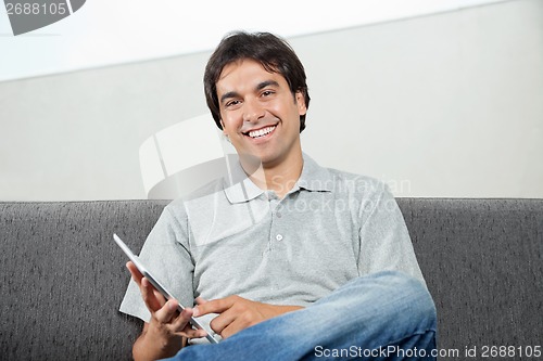 Image of Man Using Digital Tablet